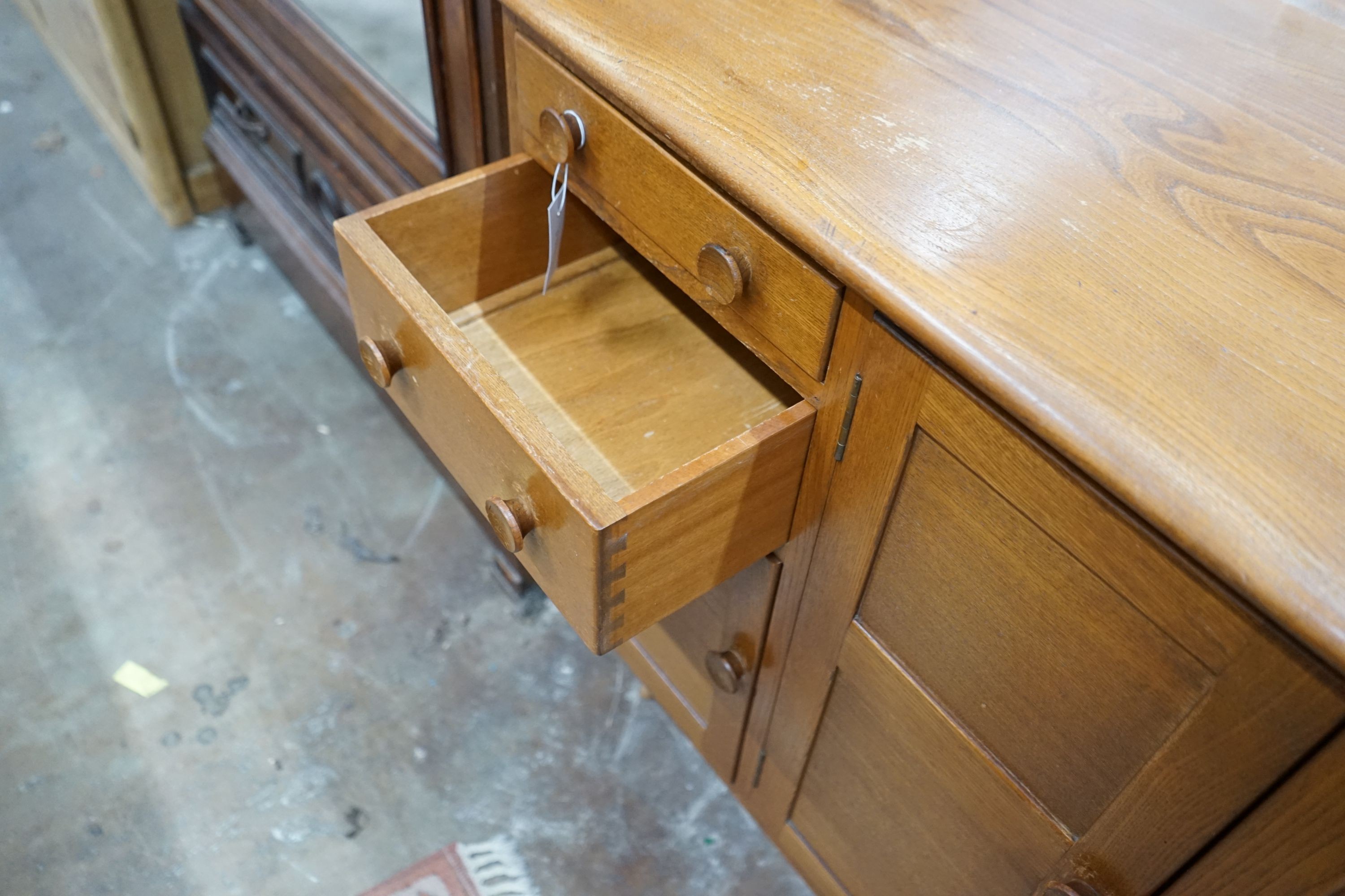 An Ercol elm sideboard, length 130cm, depth 49cm, height 86cm